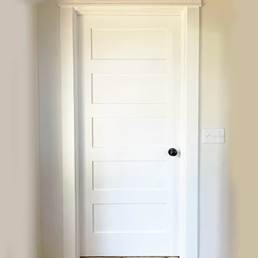 A white door with a black handle